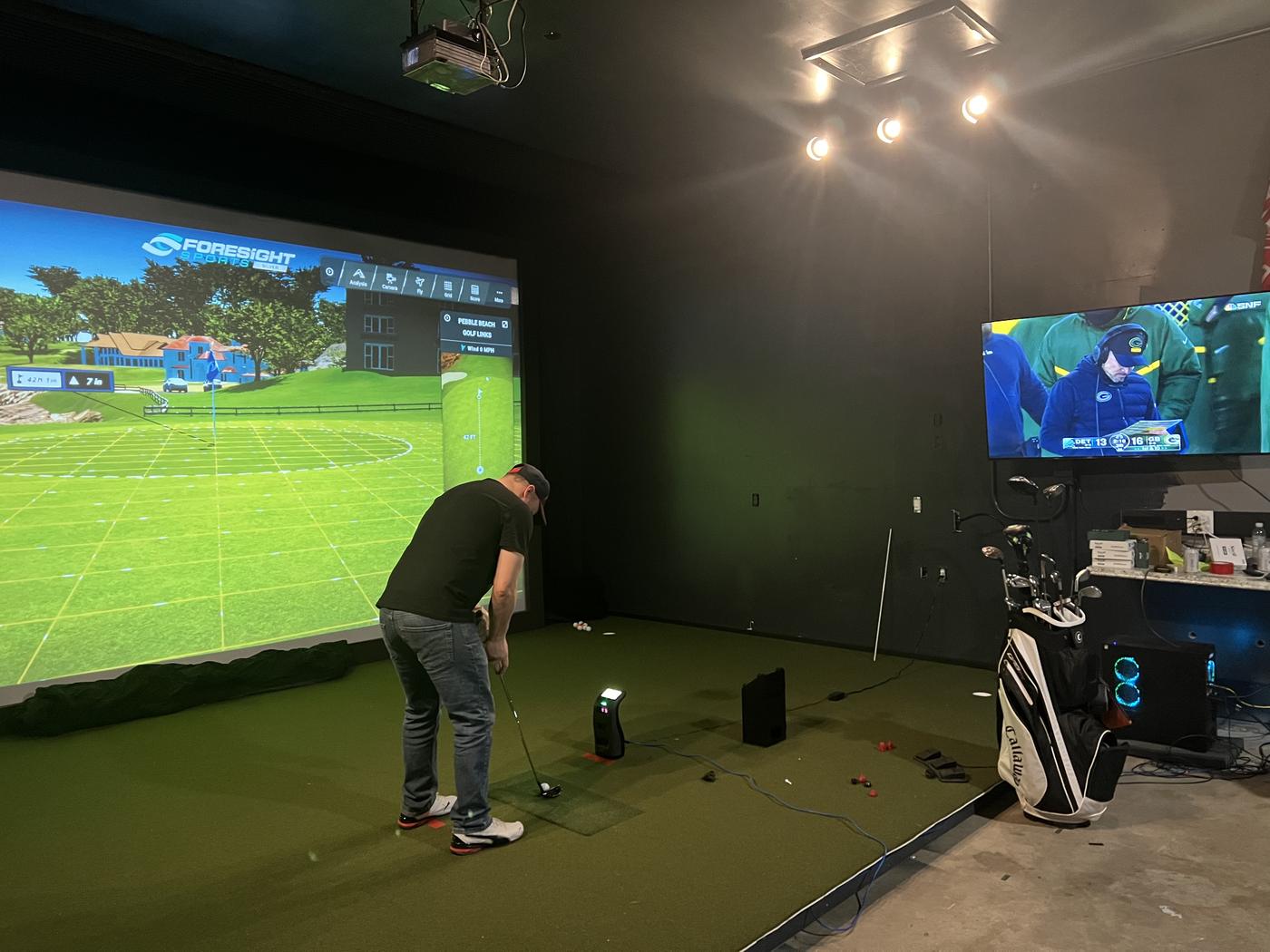 A golfer mid-swing in the bay